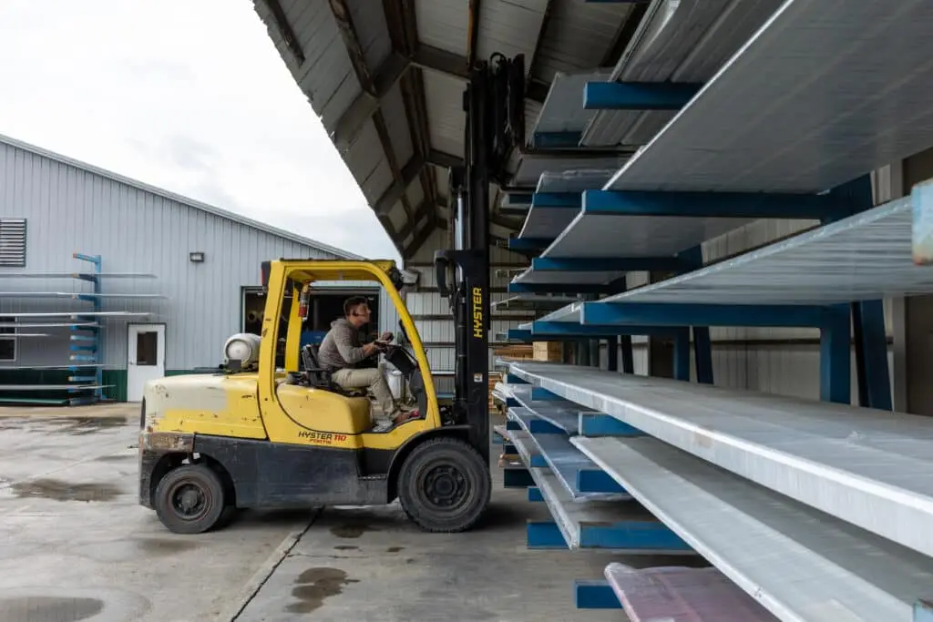 yellow-forklift-loading-metal-roofing-material