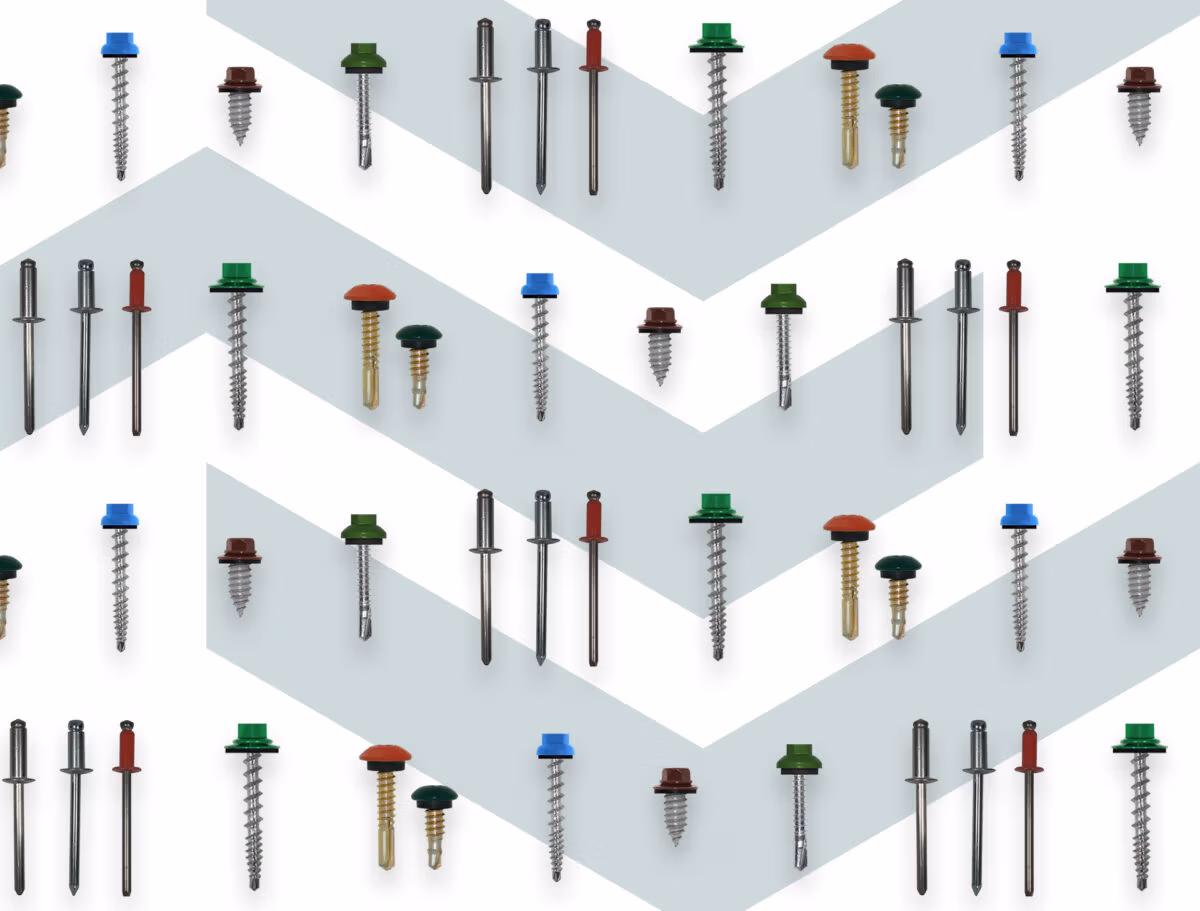 Colorful roofing fasteners arranged in rows, including screws with matching caps in red, green, blue, and brown.