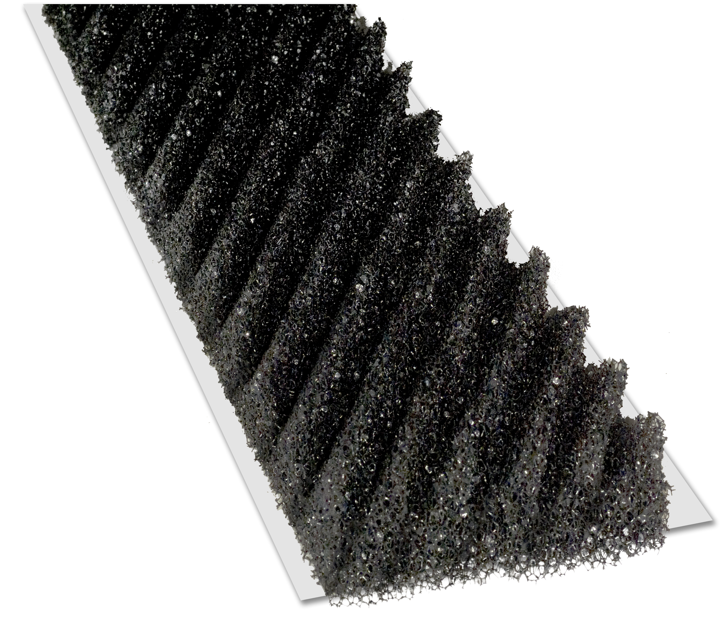 A close-up of a black corrugated foam ridge vent strip with angled bristle-like fins mounted on a white plastic base, used for roof ventilation.