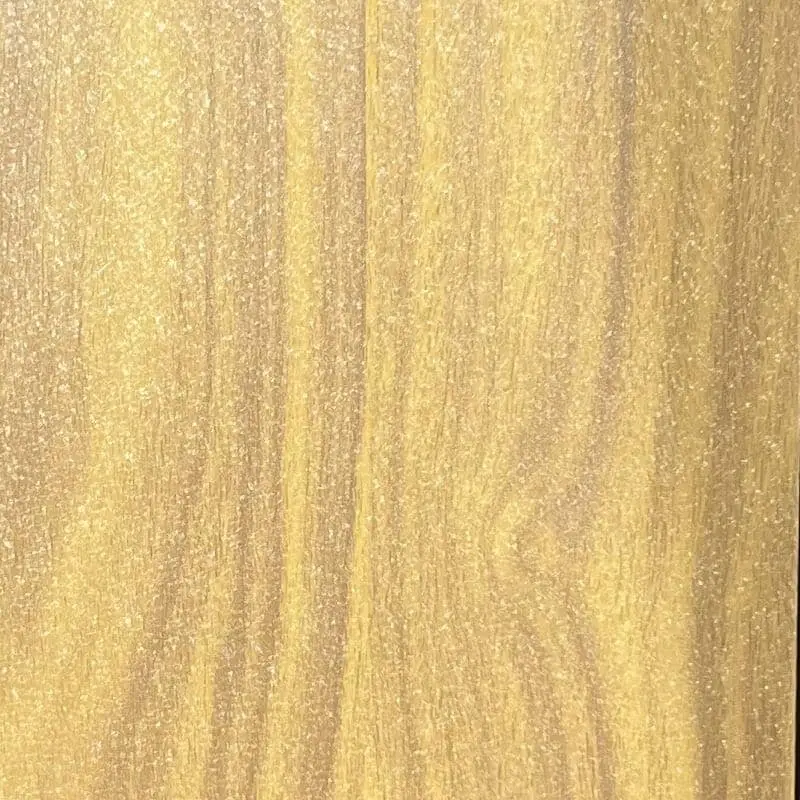 A close-up of a painted wood-grain panel with warm golden-yellow tones, subtle brown streaks, and vertical grain patterns mimicking natural hardwood.