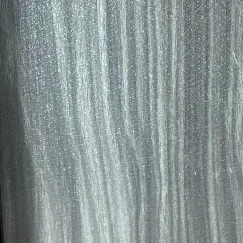 Close-up of a silver-gray painted panel featuring a convincing vertical wood-grain texture with white streaks and subtle shimmer.