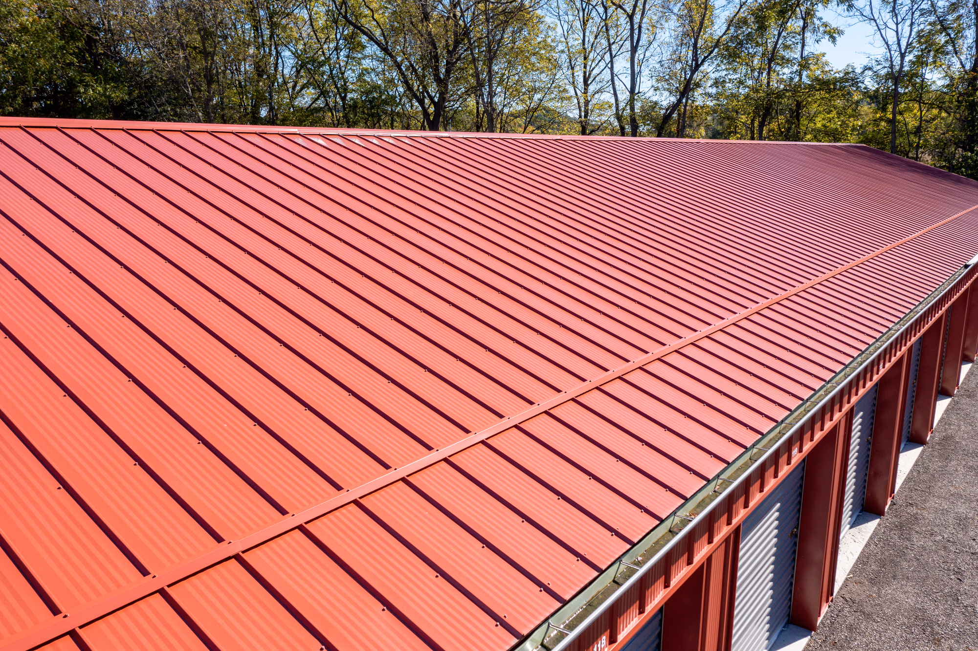 Red Buckeye Wave metal roof with rippled wave pattern panels installed on residential building with gutters visible