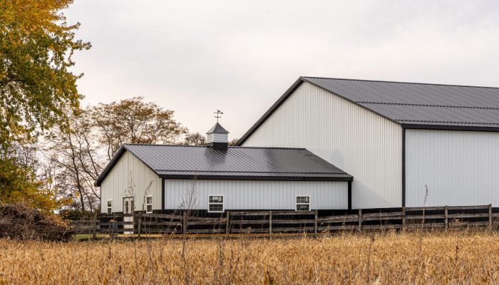 white-metal-pole-barn-black-metal-roof