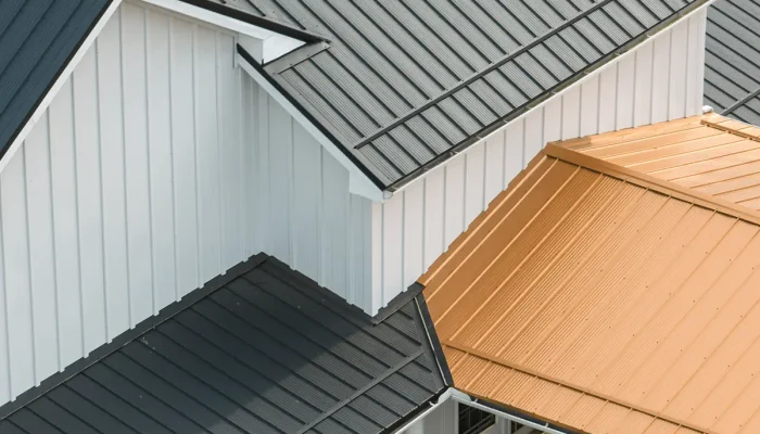 Black metal roof on a white house